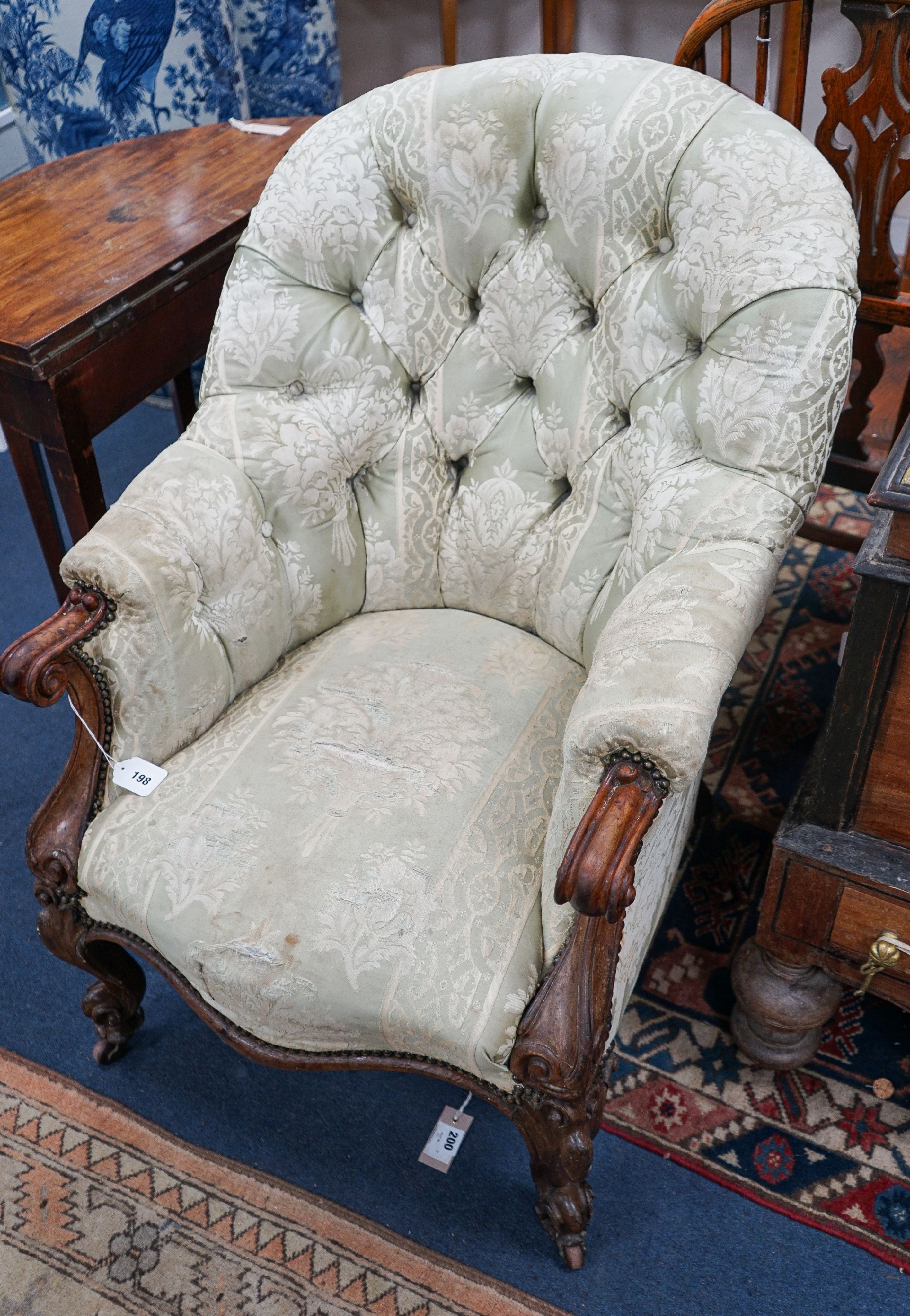 A Victorian rosewood upholstered spoon back armchair